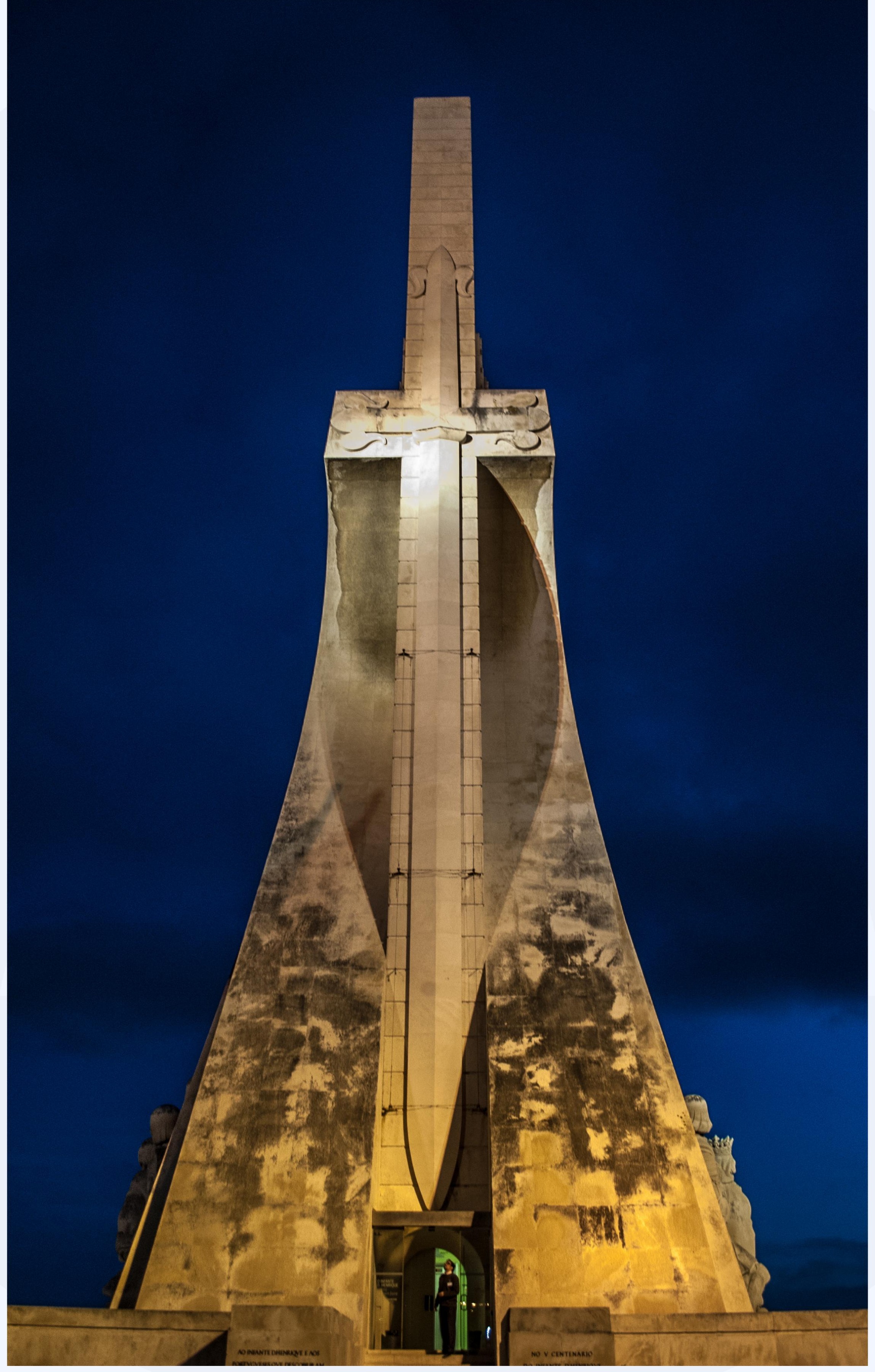 Tall concrete monument lit at night